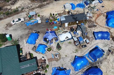 Woman creates backyard tent community for hurricane victims-army tent